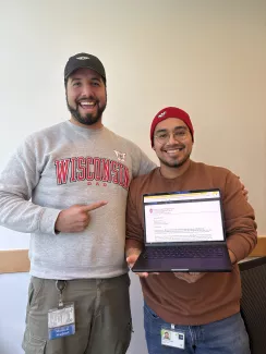 Marco holding his acceptance e-mail in the company of his mentor Ernesto